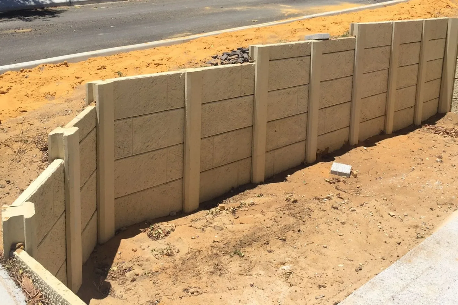 Roadside concrete retaining wall under construction