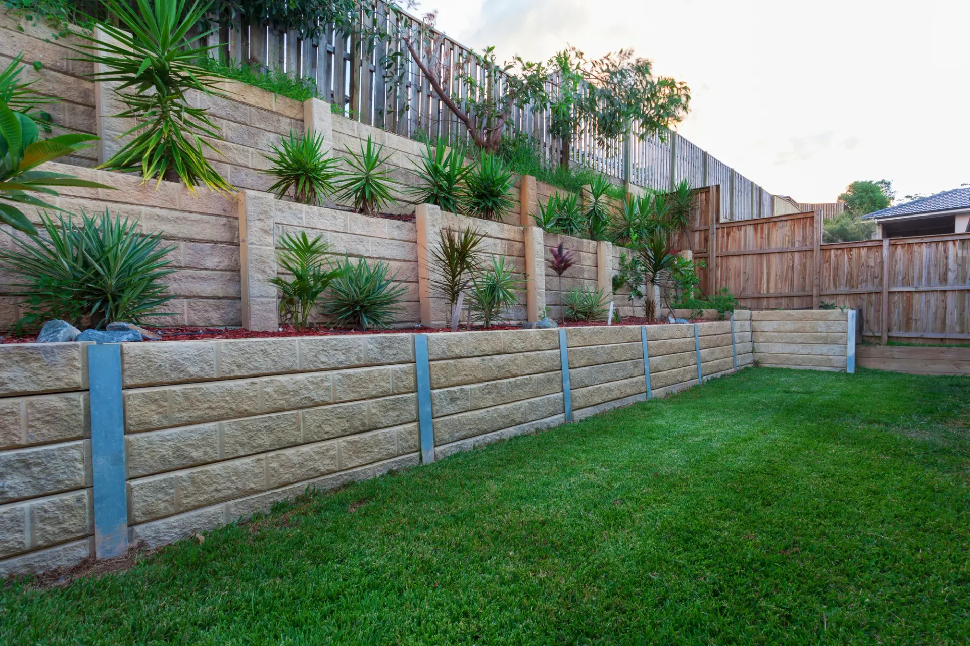 Sandstone retaining wall and steps at a landscaped Toowoomba property