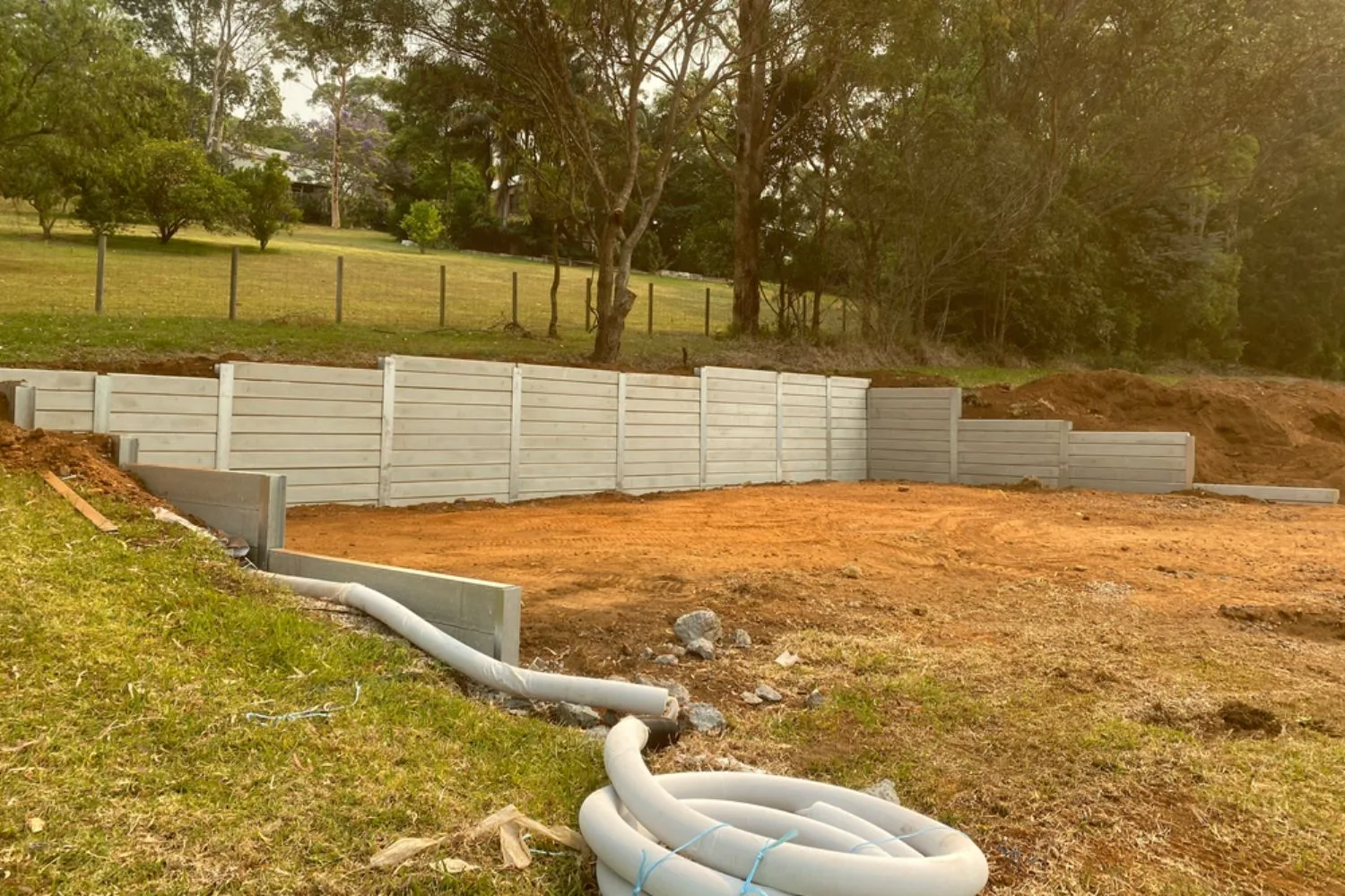 Concrete sleeper retaining wall under construction