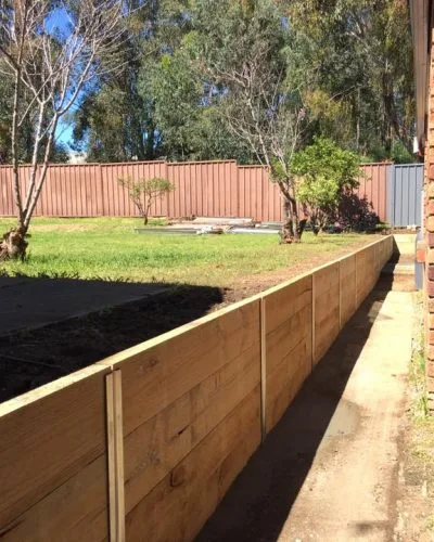 Timber retaining wall along a rear fence line