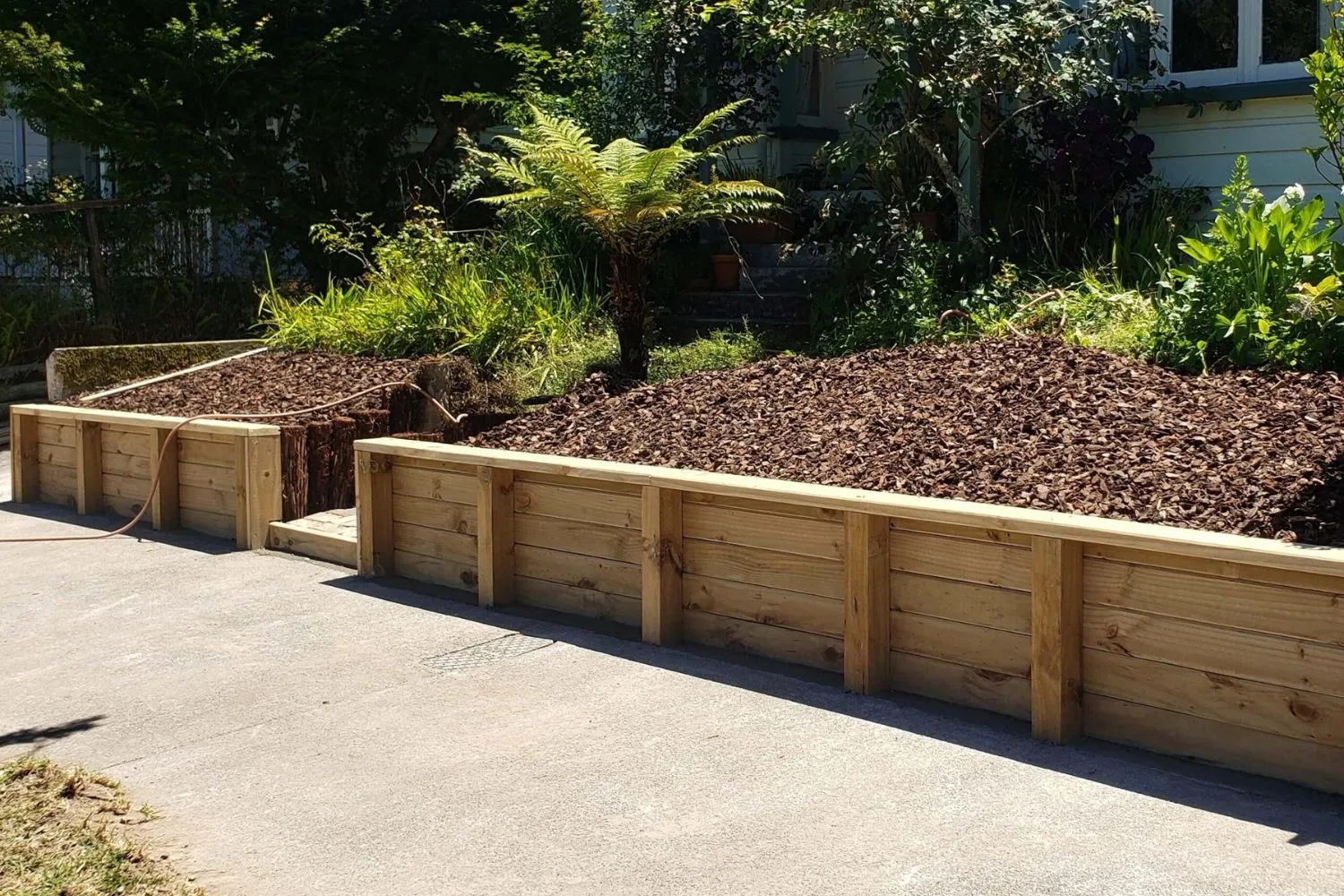 Timber retaining wall with mulched garden bed